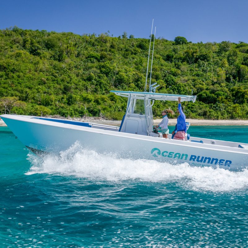 a person riding on the back of a boat in the water