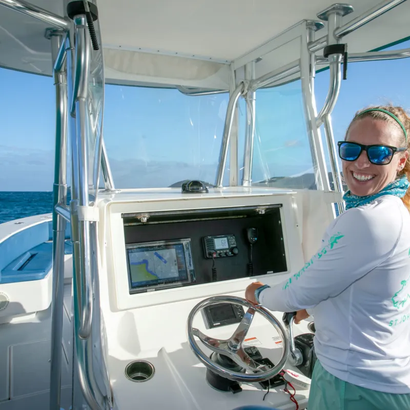 a woman standing on a boat in the water