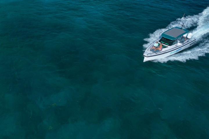 a person riding a wave on top of a body of water