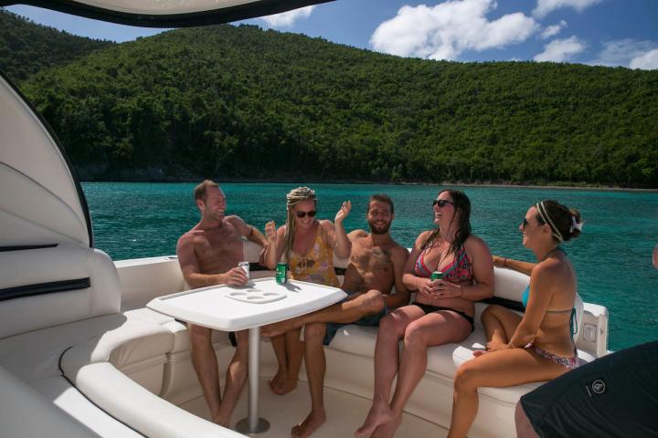 a group of people sitting in front of a lake
