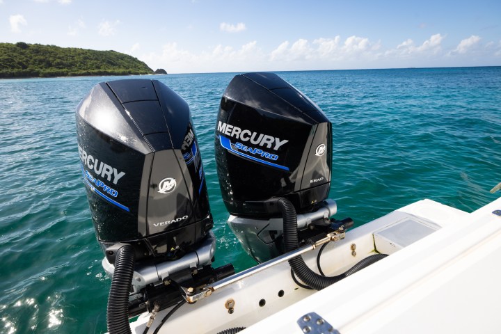 Two Mercury SeaPro boat engines on a boat in open water.