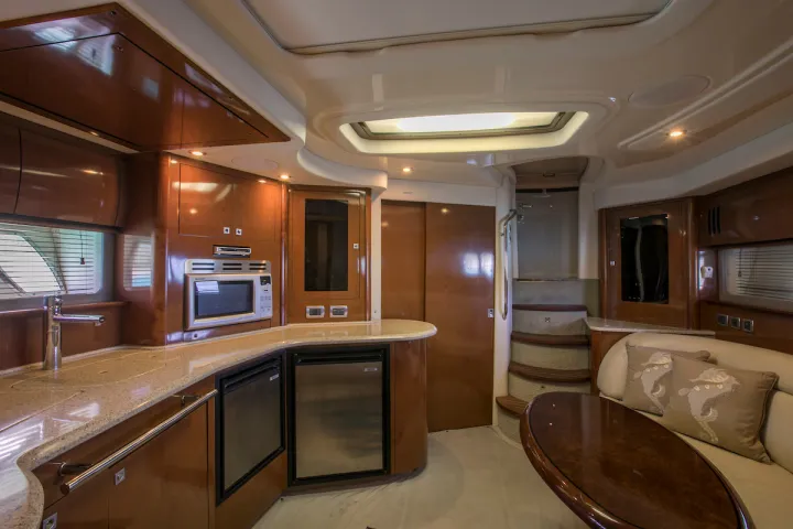 a large kitchen with stainless steel appliances and wooden cabinets