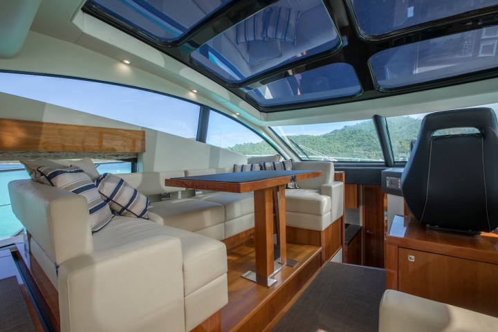 a desk with a computer and a chair in a room