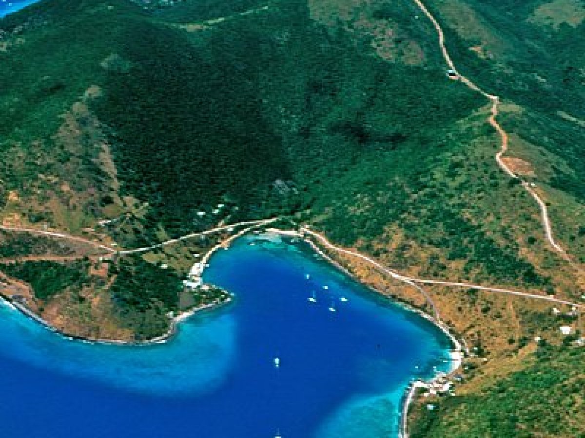 a body of water with a mountain in the background
