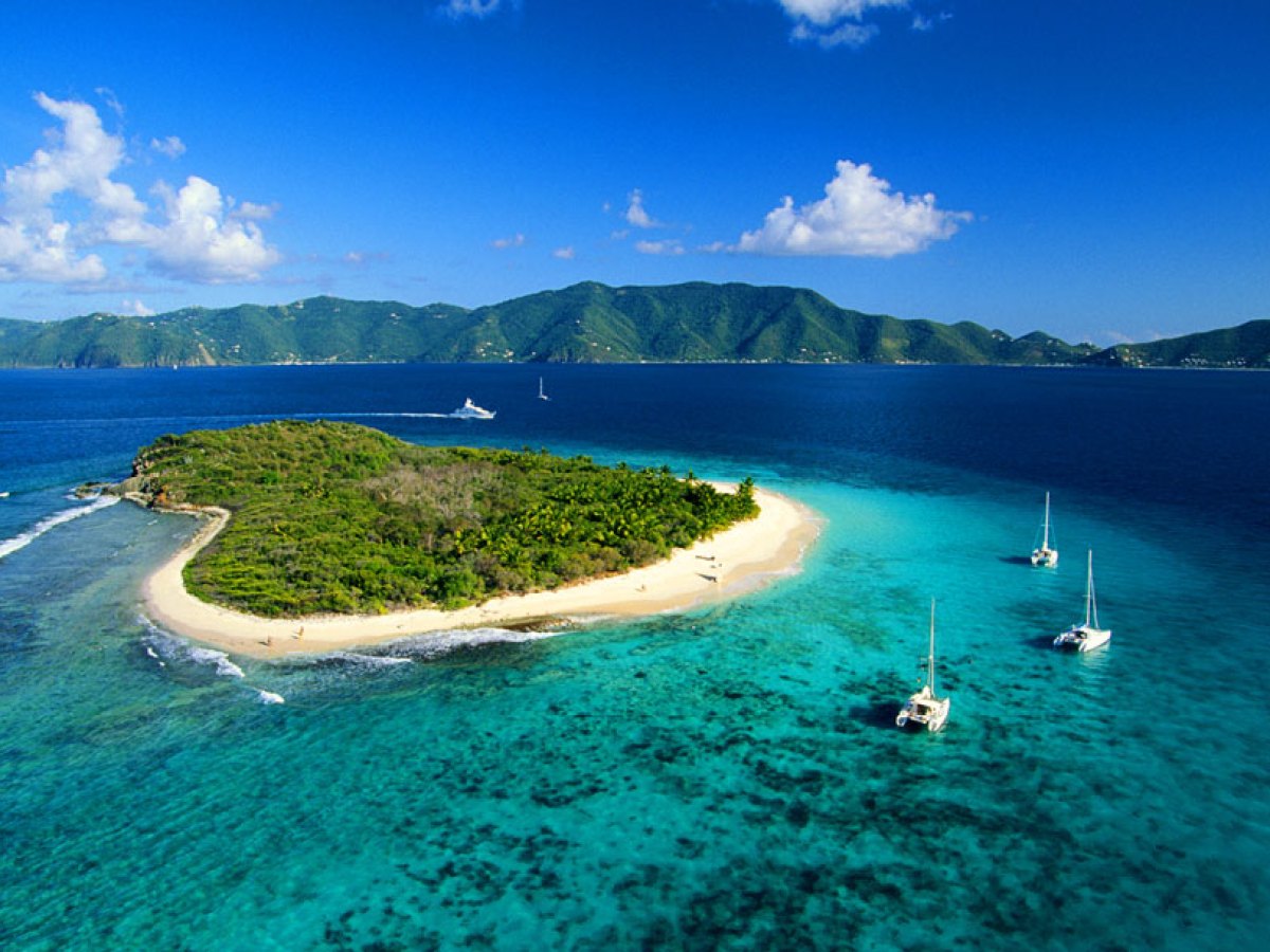 a small boat in a body of water with a mountain in the background