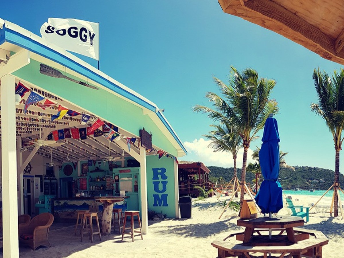 a group of people sitting at a table in front of a building