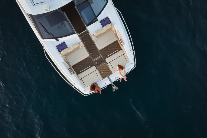 Aerial view of two people on a boat in the ocean.